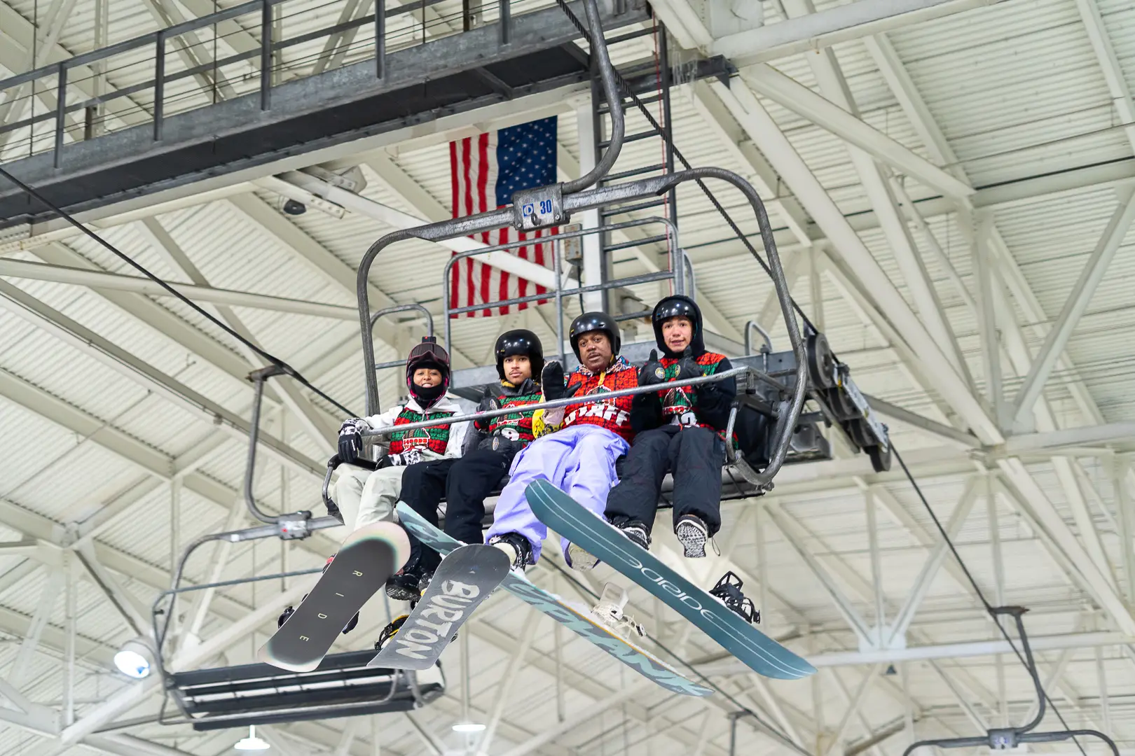 Home Page 9 Participants riding a chair lift